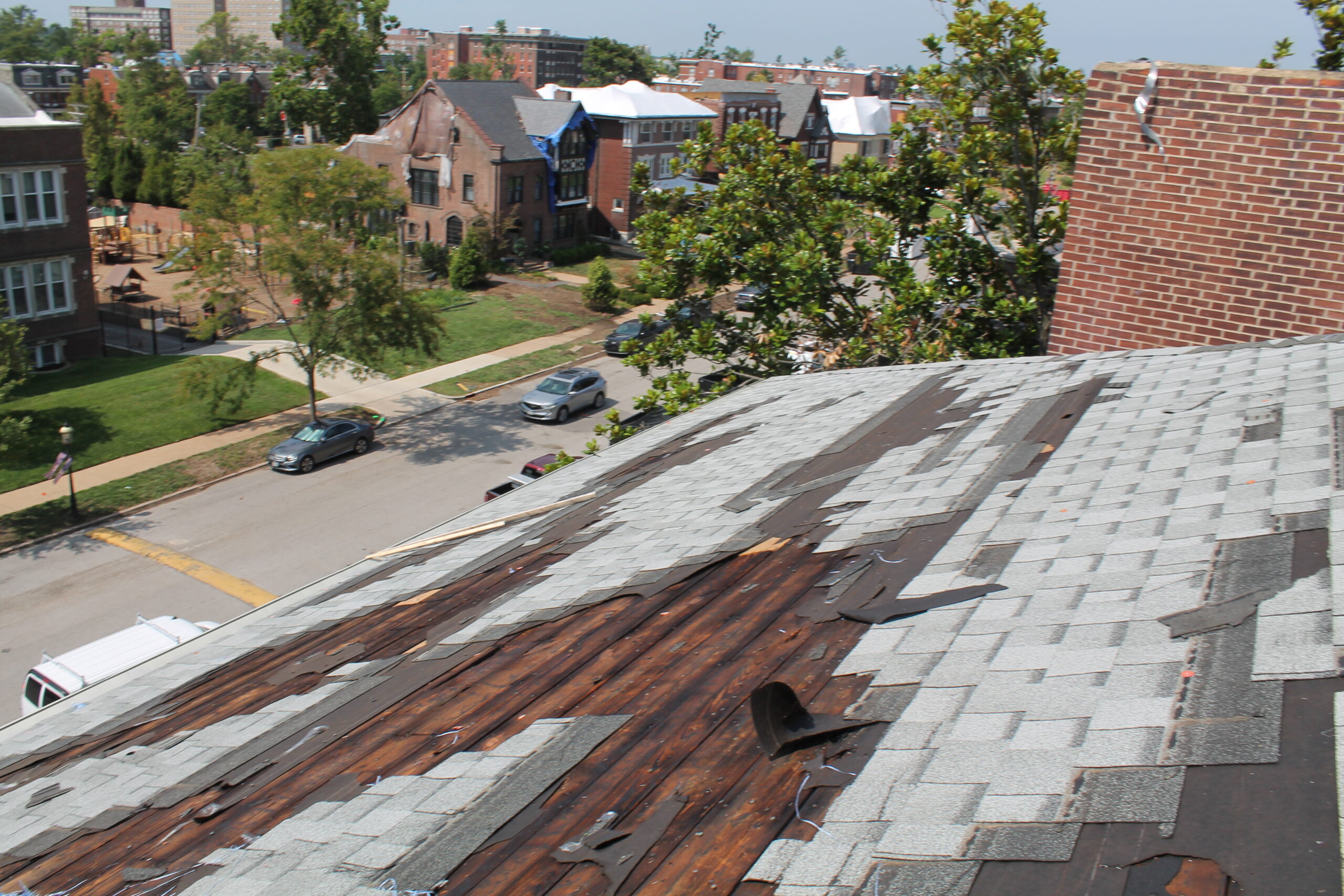 View of slate roof with extensive damage due to tornado.