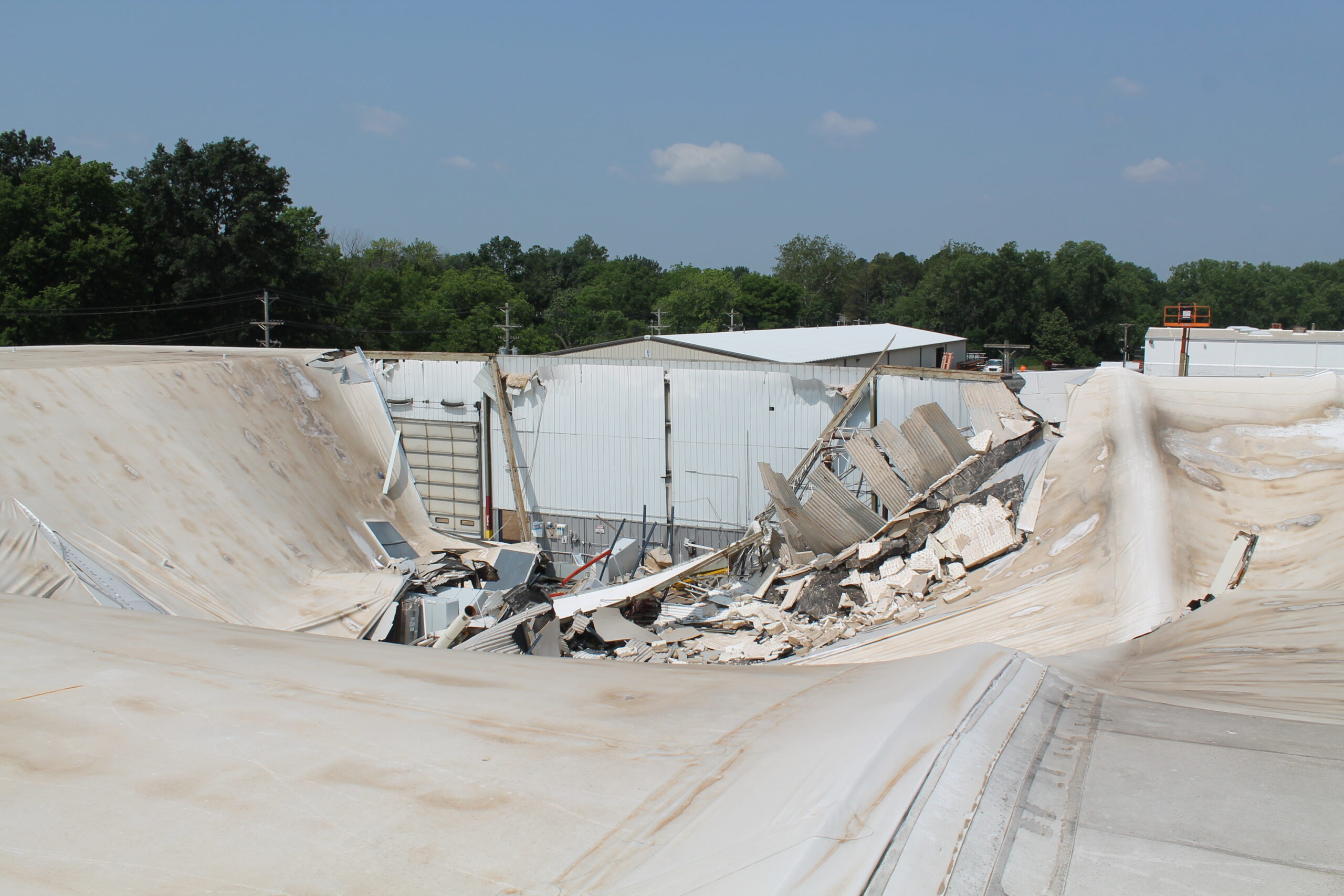 View from the sky of a demolished roof of a building due to storm.
