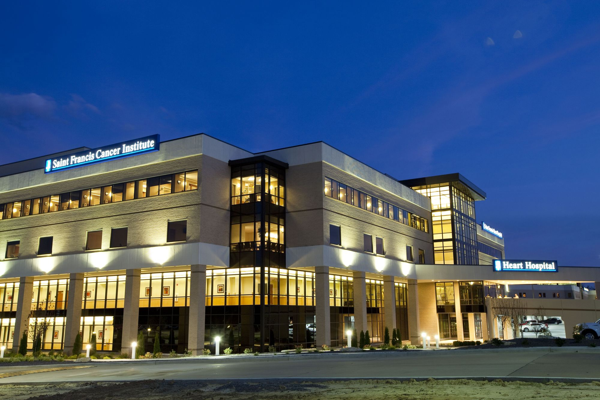 View of hospital at night with interior lights on and dark sky