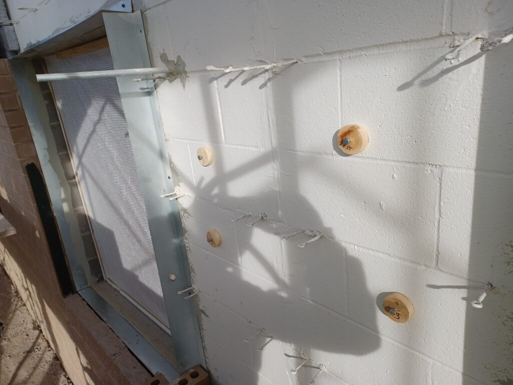adhesion testing circular marks on brick painted exterior wall