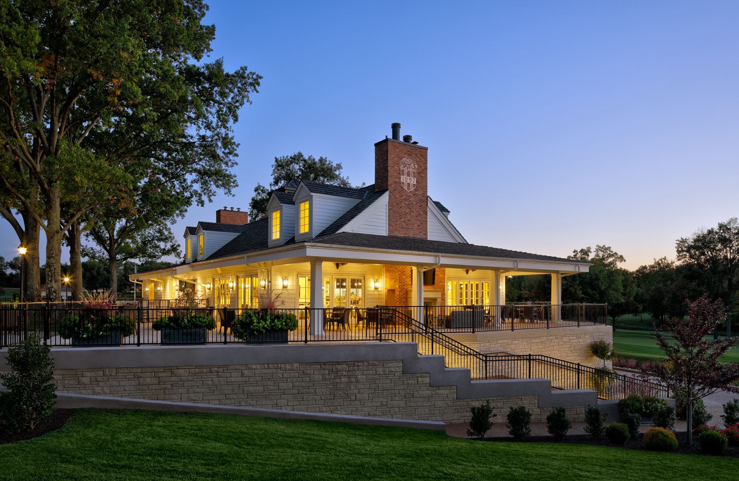 The clubhouse at Bellerive Country club lit up at night.