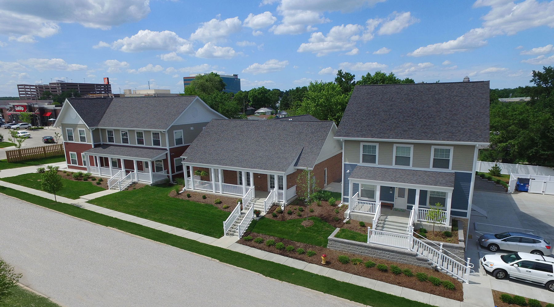 Three distince, residential-scale structures connected by a continuous basement below grade.