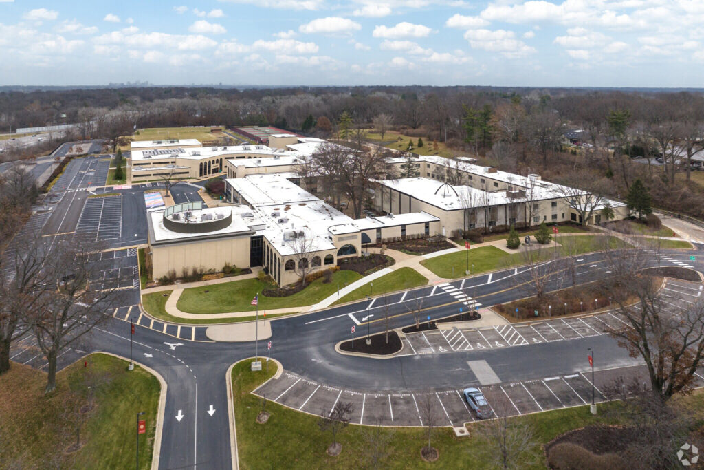 Drone view of visitation academy campus including parking lot and buildings