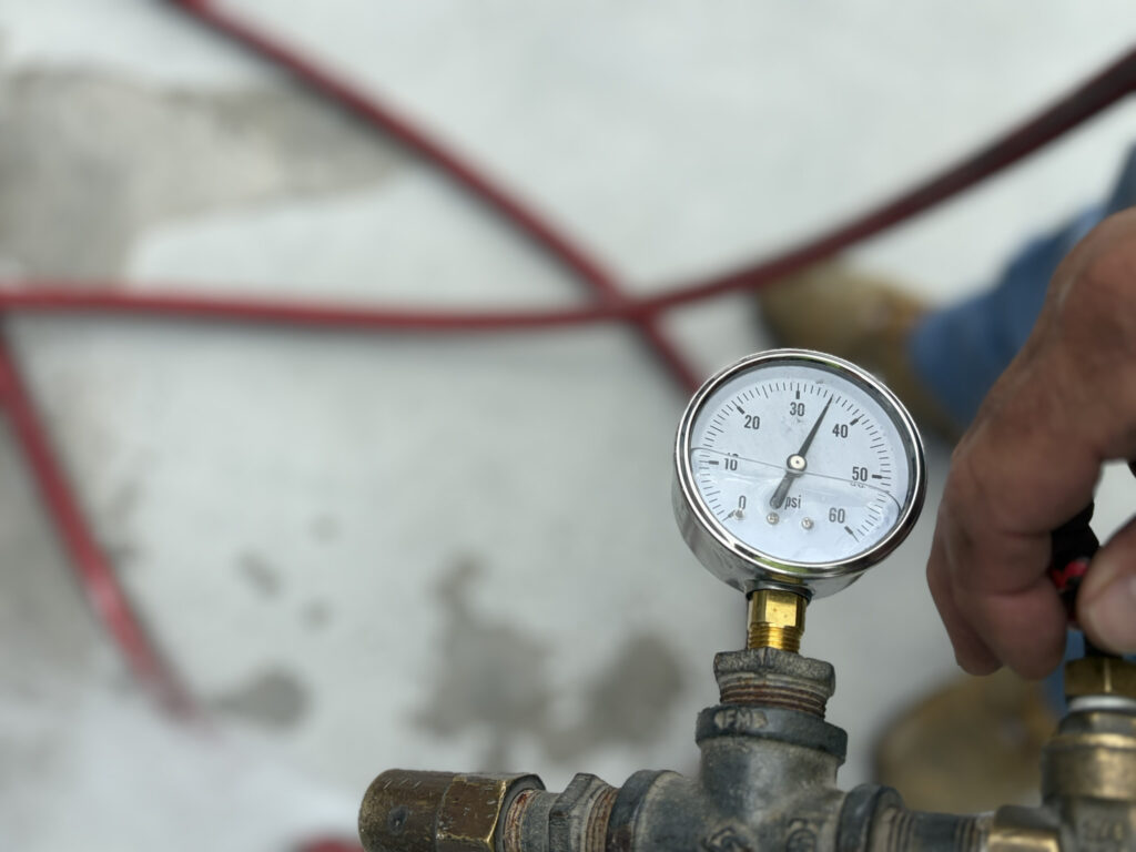 Water pressure gauge connected to hose.