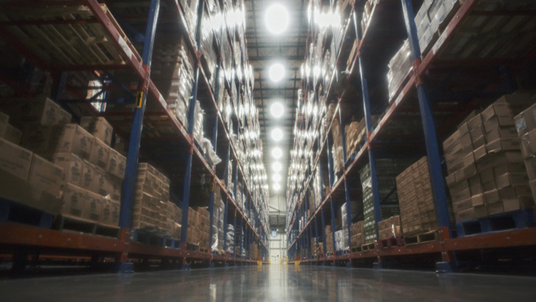 Shelves of supplies and product on the left and right inside the warehouse at Dot's Food in Mount Sterling IL