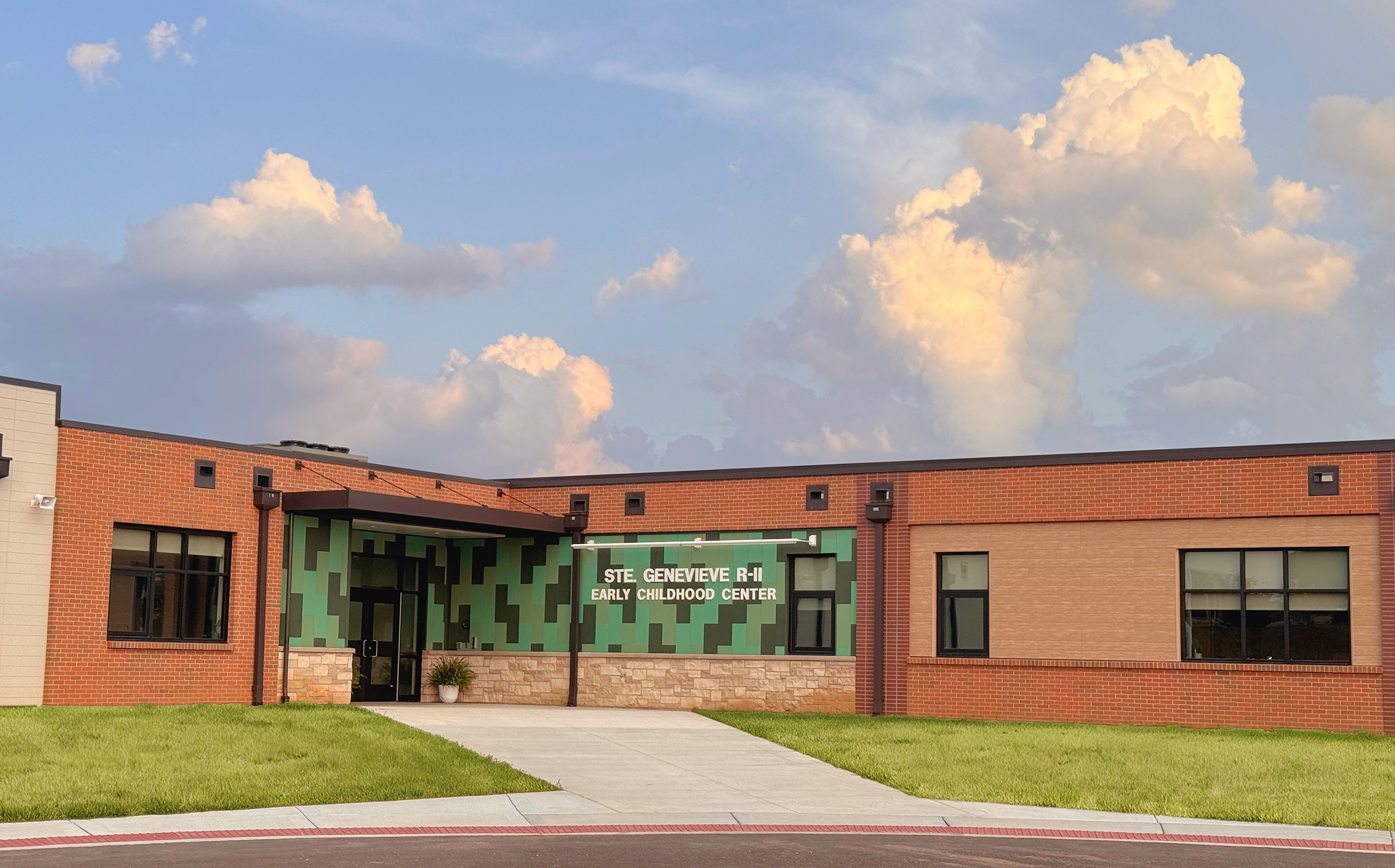 Brick and stone entrance to the ECC with blue sky and clouds in sky