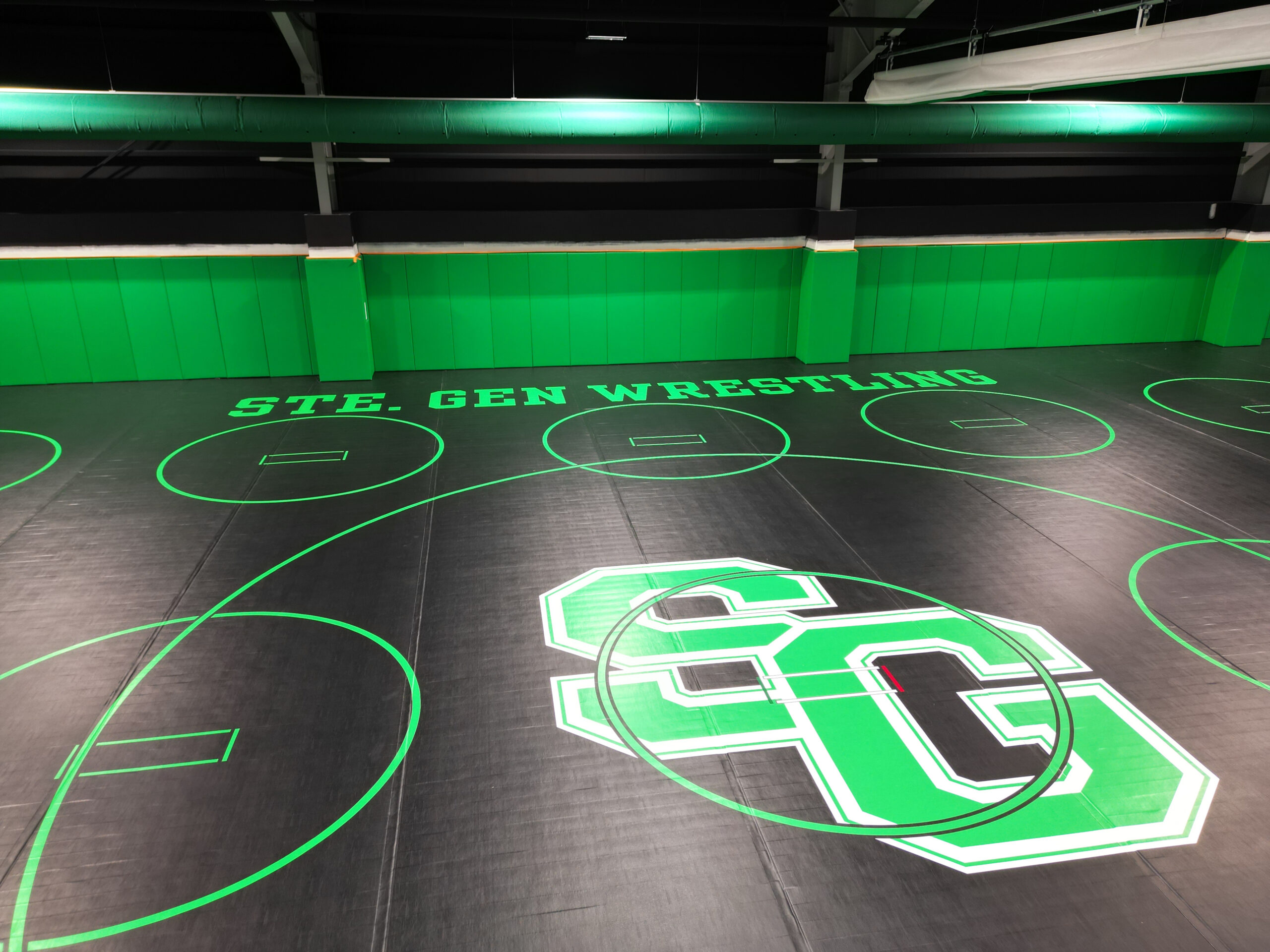 Black wrestling mats inside the updated wrestling room with the Green "SG" logo for Ste. Genevieve School District