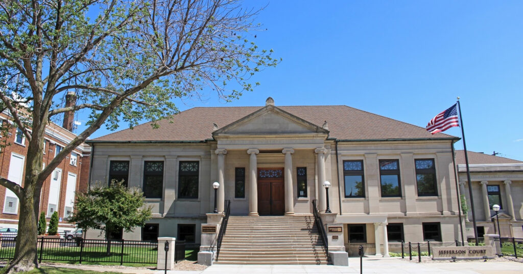 Front of two story stone courthouse built in 1903 in Greenbay, WI