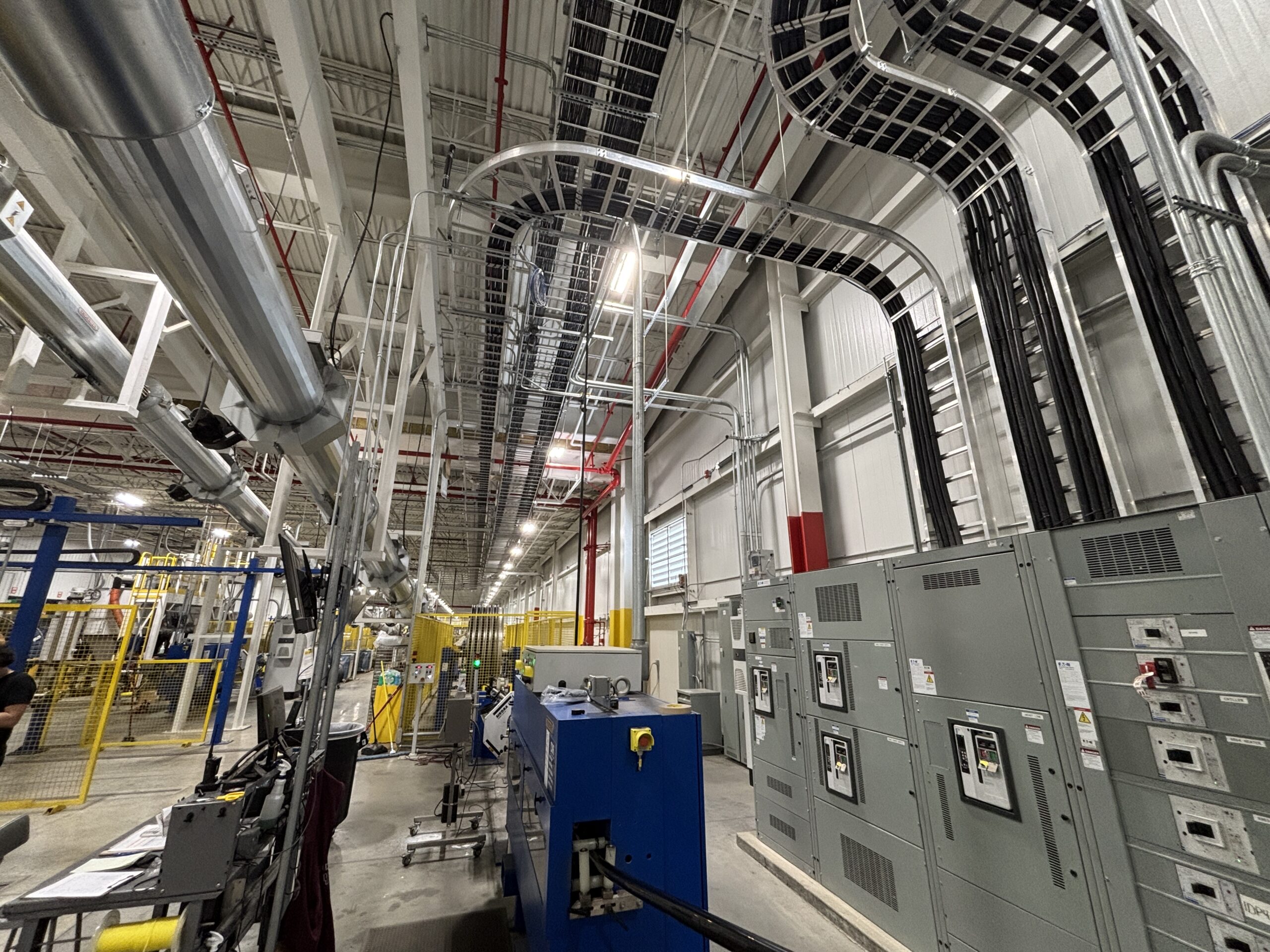Cable tray and conduit routed overhead to electrical switchgear inside the Prysmian production facility in Du Quoin, Illinois.