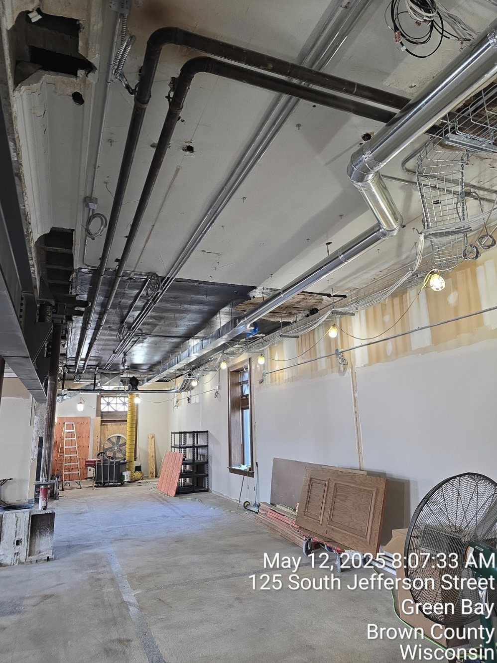 New ductwork and conduit routed along the original plaster ceiling on the second floor of the Jefferson Court Building at 125 South Jefferson Street, Green Bay.