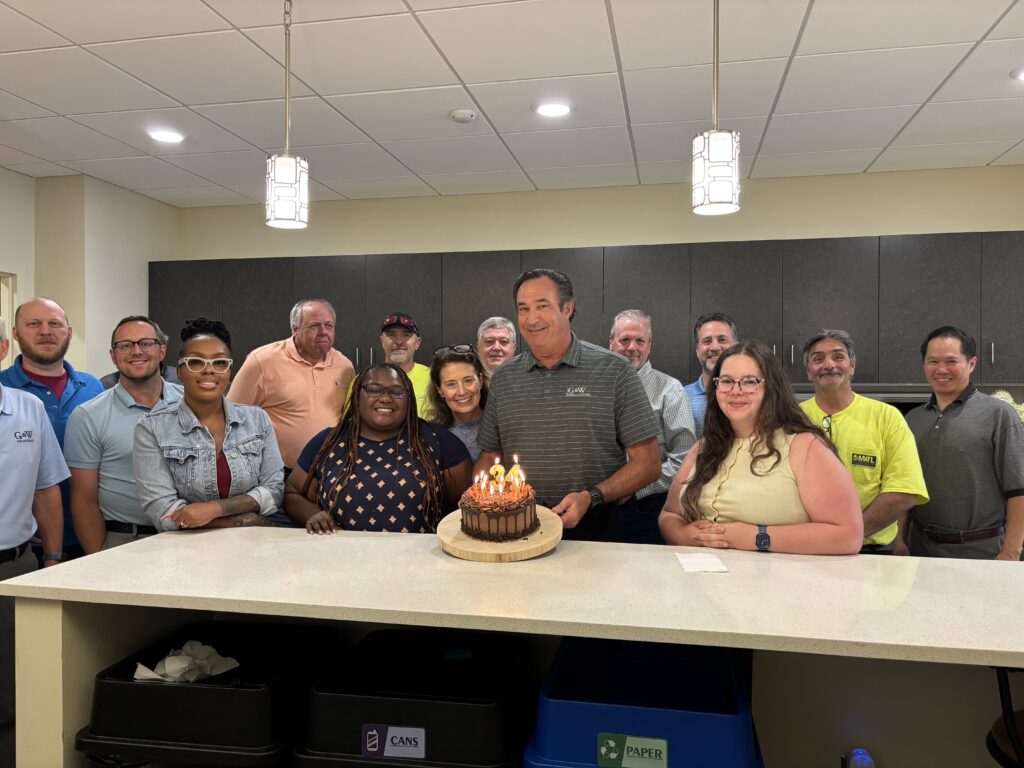 G&W team members surrounding owner, Kevin Griesemer, holding the 34th anniversary birthday cake.