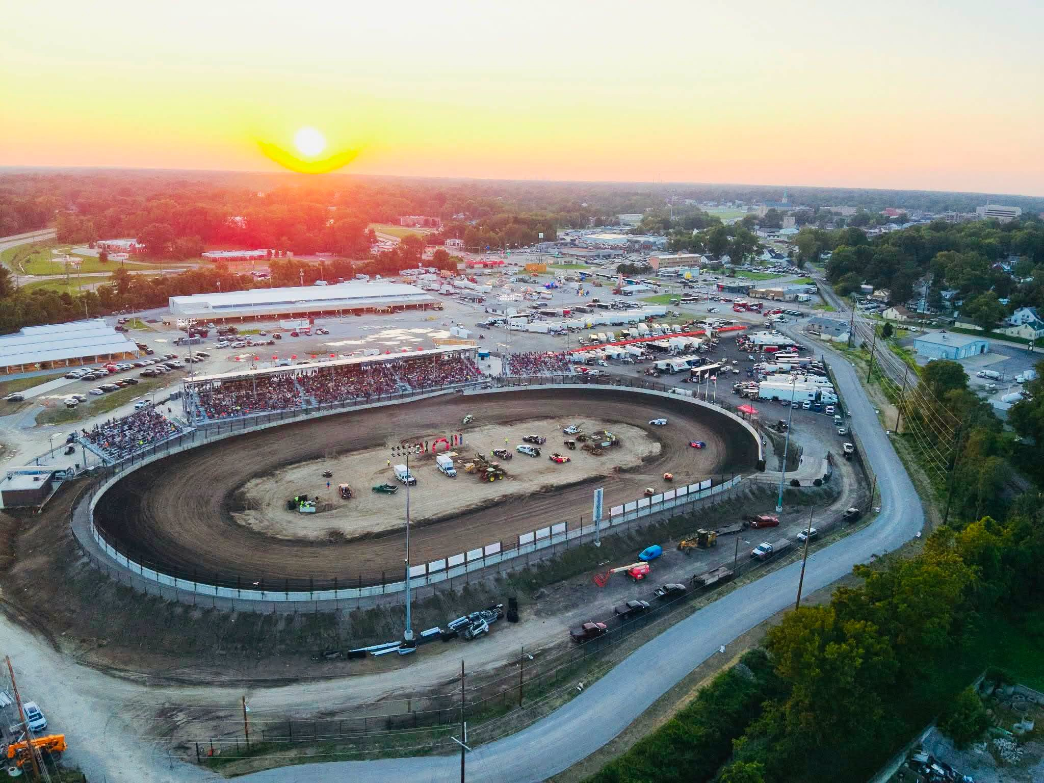 Aerial view at sunset of the new quarter-mile dirt oval at Belle-Clair Fairgrounds in Belleville with full grandstands and the fairgrounds beyond